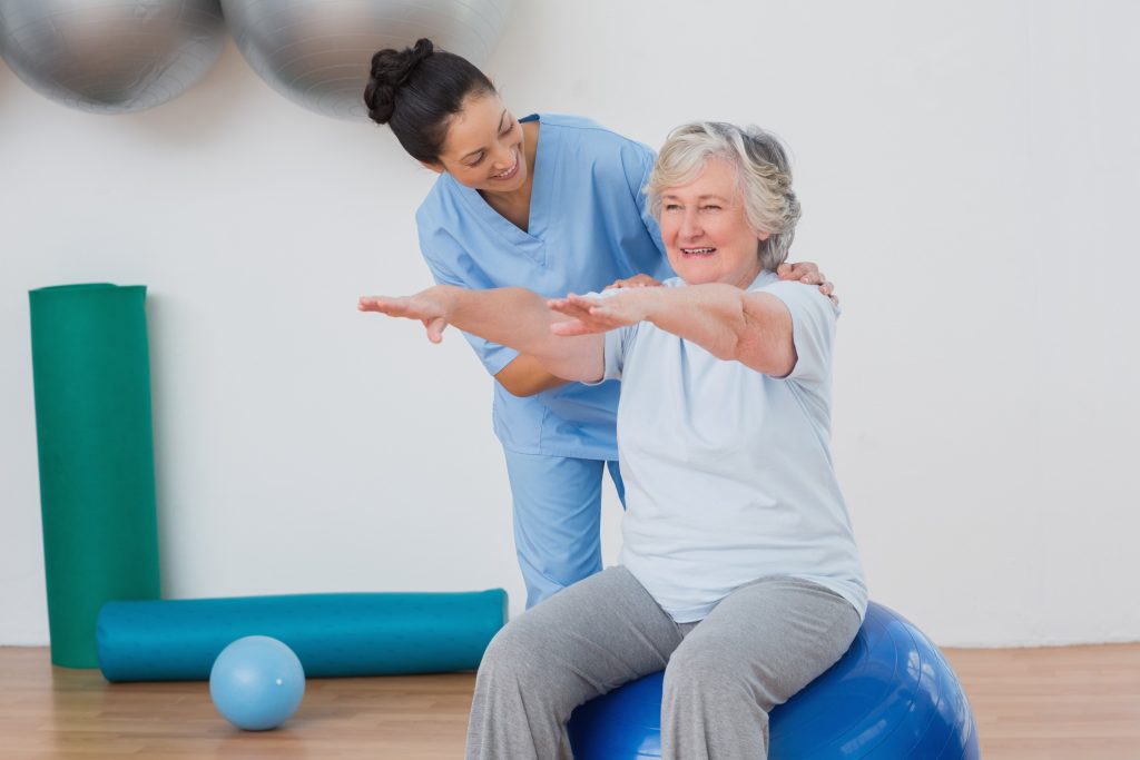 Physical Therapist helping older lady