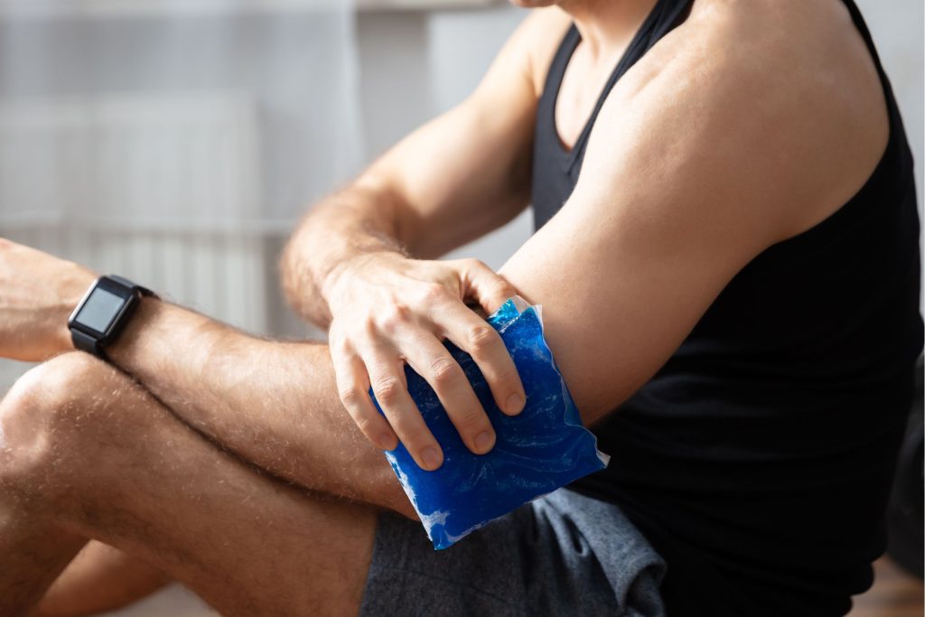 Man holding ice pack to arm